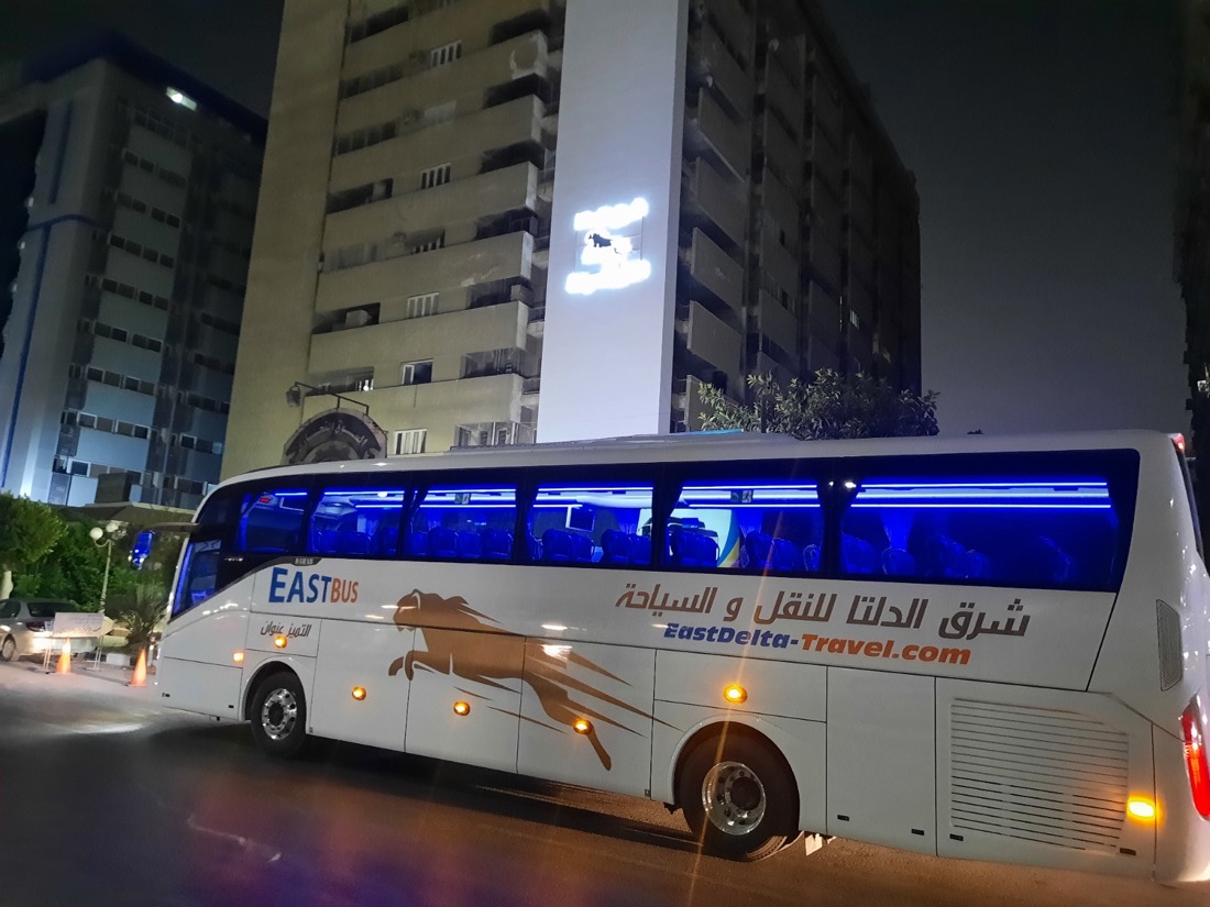 East Delta coach parked at night with blue interior lighting