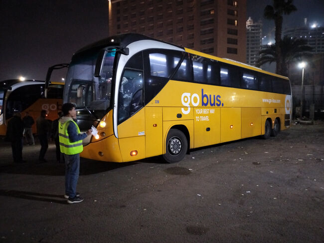Go Bus coach at a night terminal before boarding