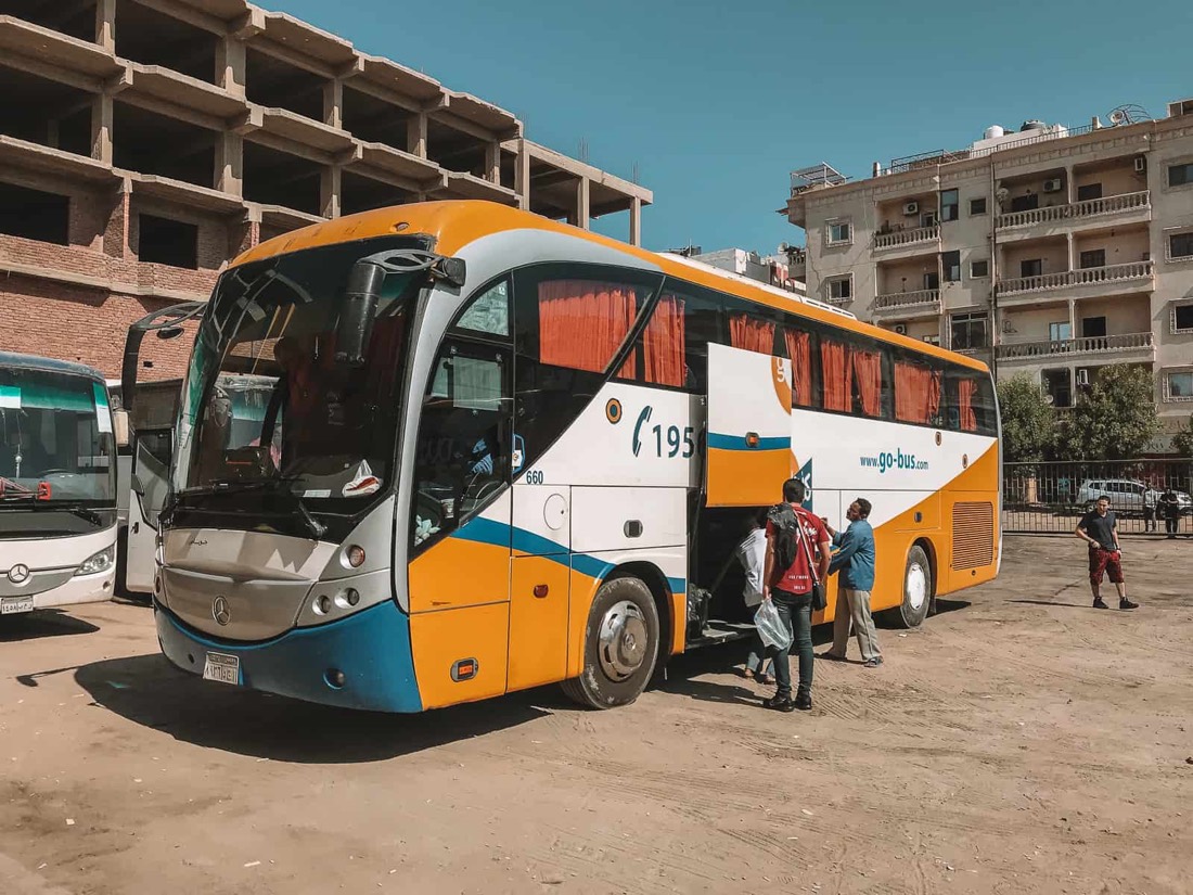 Passengers loading luggage into a Go Bus coach side compartment in Egypt
