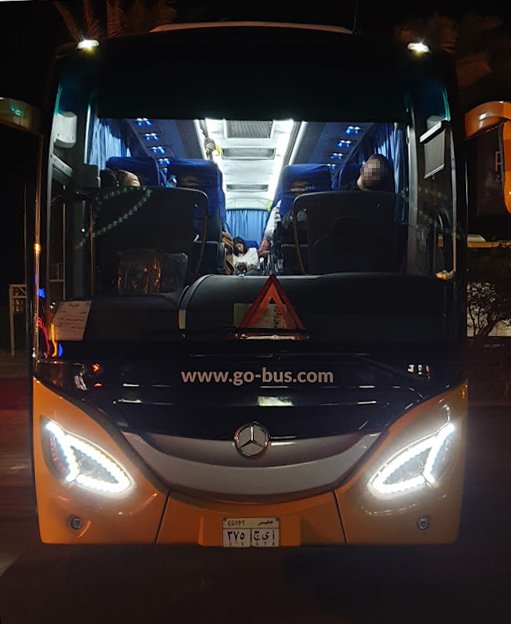 Go Bus coach waiting at night with lights on before an Egypt overnight departure