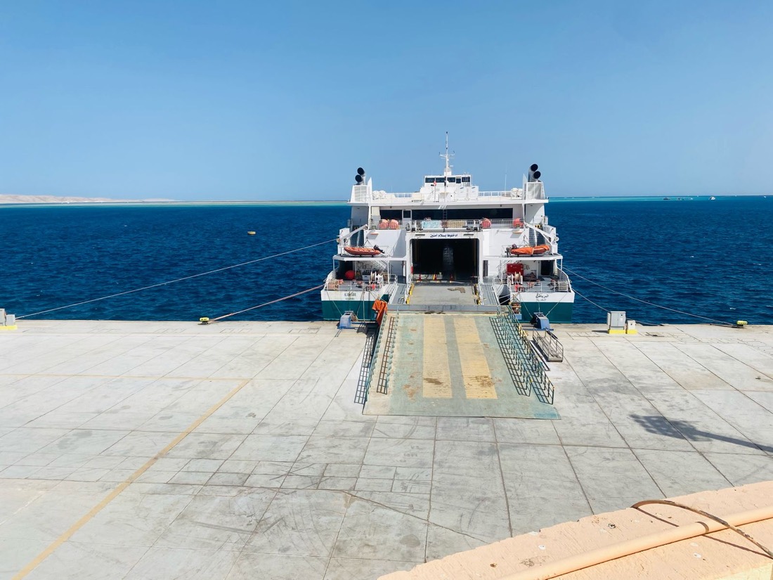Red Sea ferry docked at a port with loading ramp open