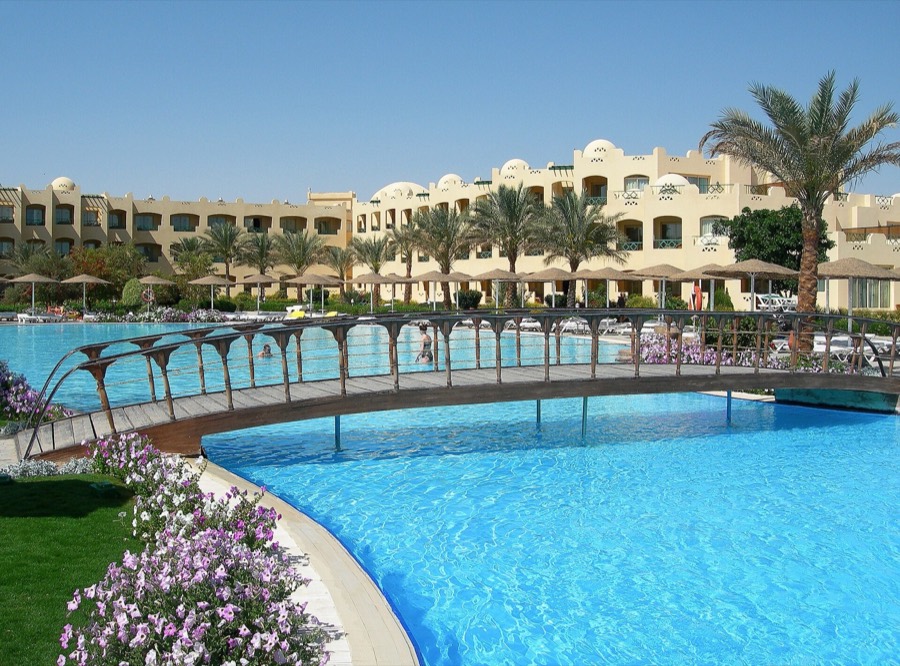 Resort pool and palm trees in Makadi Bay
